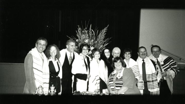 A group of adult members of Congregation Kol Ami receive their Bar and Bat Mitzvahs from Cantor Mark Saltzsman (far left), and Rabbi Denise Eger (4th from right). Circa 2000.