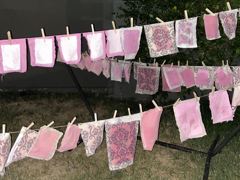 Hand-made paper drying on clothes line