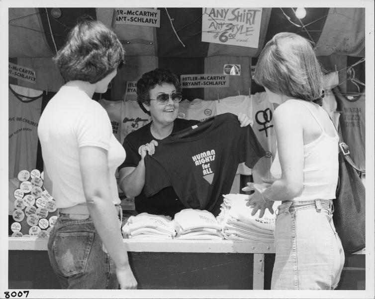 ivy selling t-shirt at festival